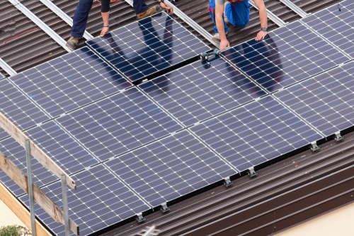 Professional solar panel installation on residential roof for renewable energy